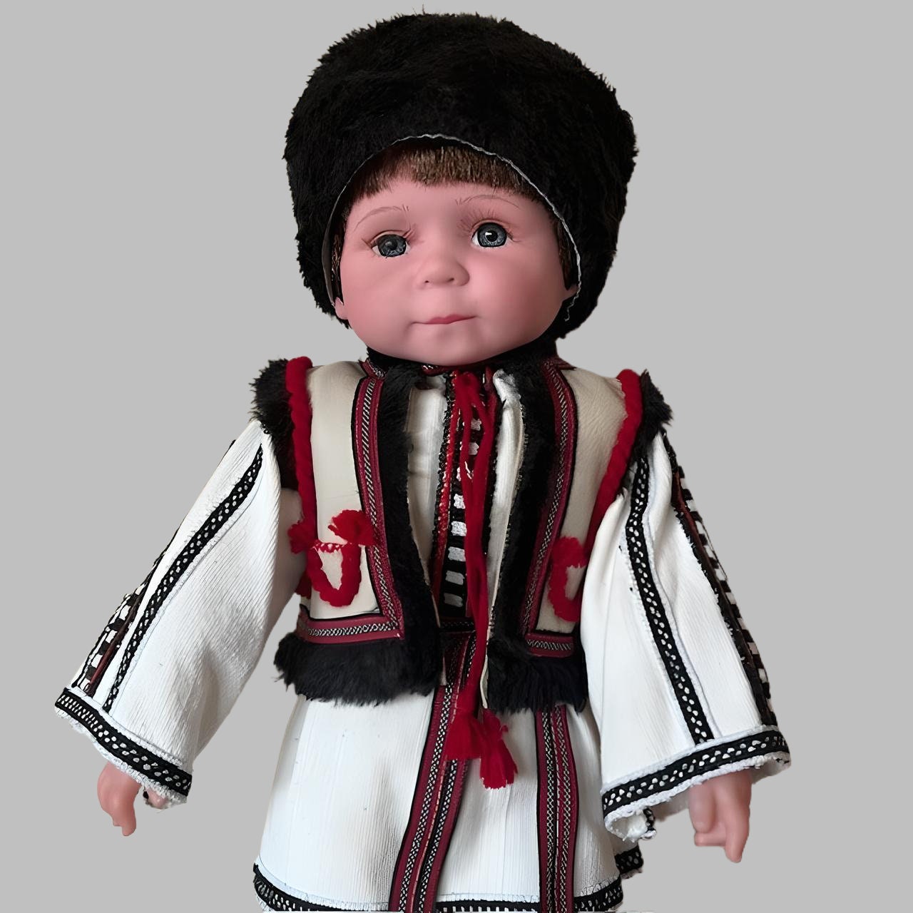 Handmade Ukrainian boy doll Vasyl in traditional Carpathian outfit with hand-embroidered details and fur headpiece.