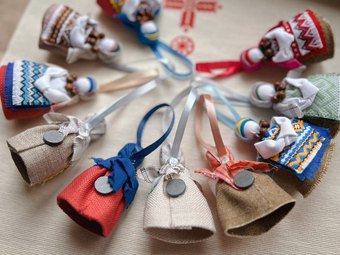 Colorful handmade Motanka dolls with magnets, featuring traditional Ukrainian patterns and designs.