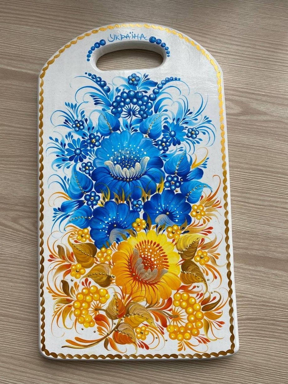 Hand-painted wooden cutting board with yellow-blue floral Petrykivka design, Ukrainian kitchen decor, unique folk art gift.