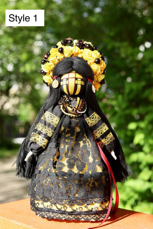 Handmade Ukrainian Motanka Doll in black and gold dress outdoors