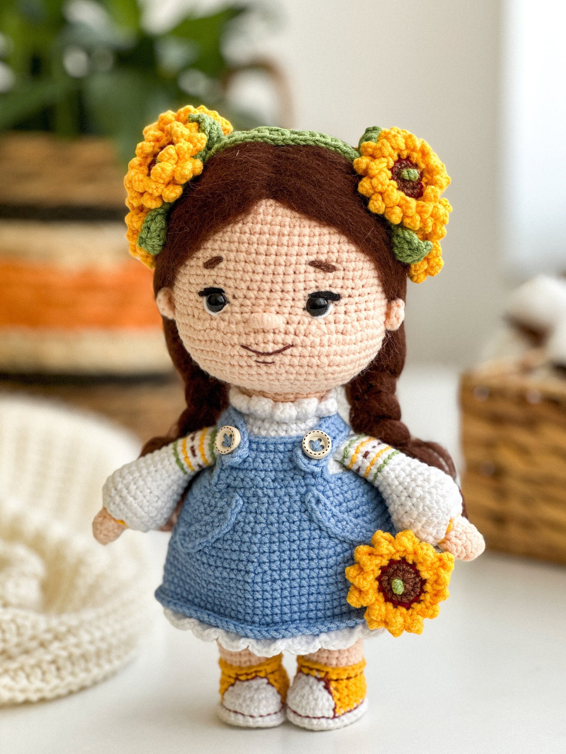 Handmade knitted doll with sunflowers, Ukrainian themed toy, soft and cozy gift, wearing blue dress and yellow accents