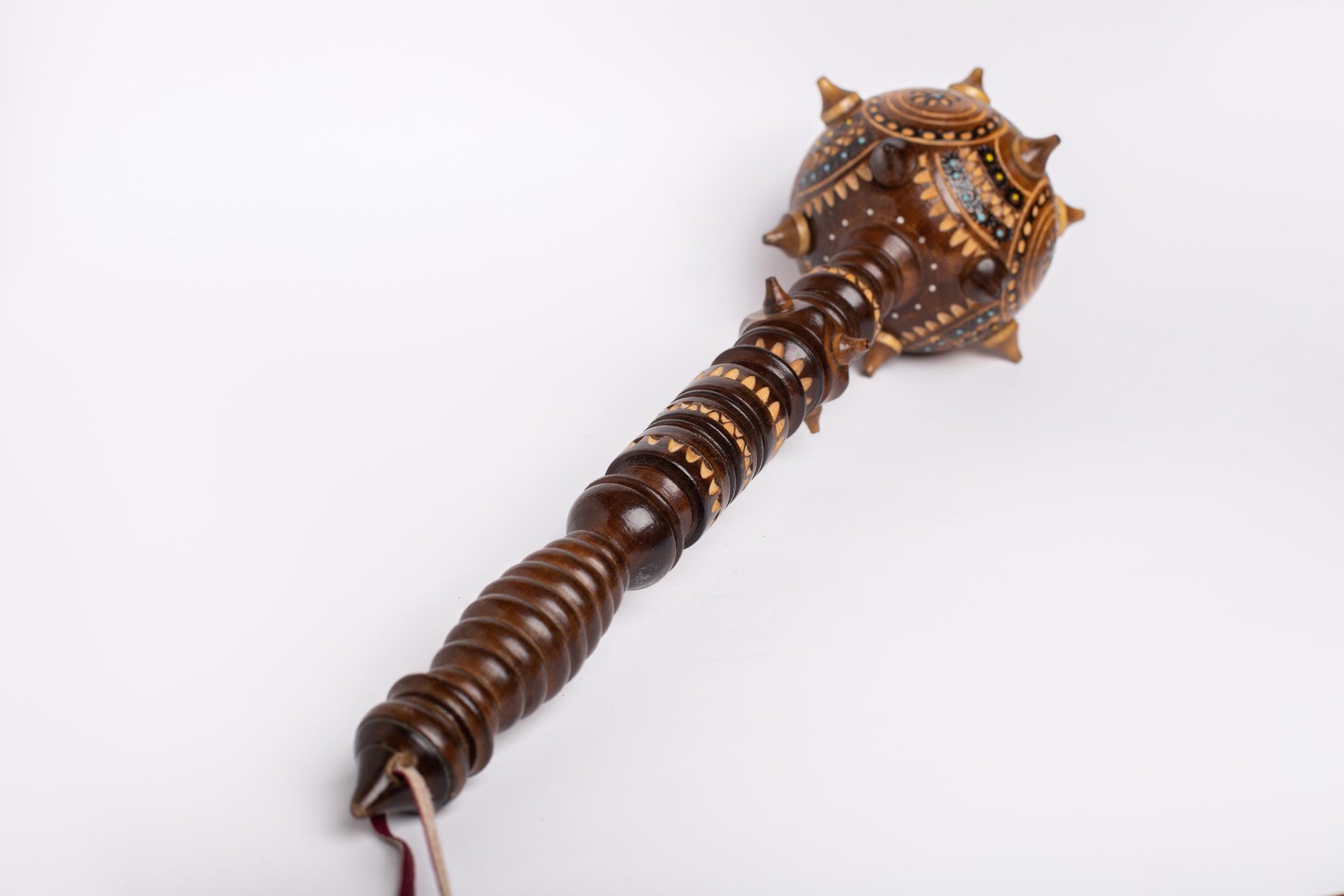 Hand-carved wooden Ukrainian bulava mace, symbol of strength, perfect decorative gift or souvenir, showcasing traditional craftsmanship.