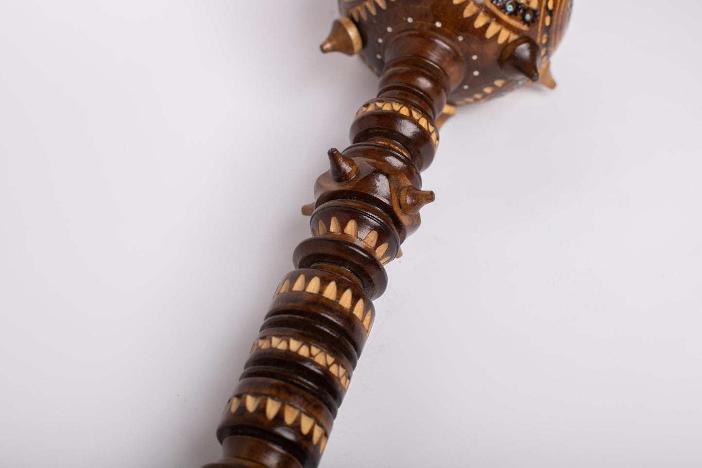 Hand-carved wooden mace with intricate Ukrainian design, symbolizing strength and leadership, perfect for a unique decorative gift.