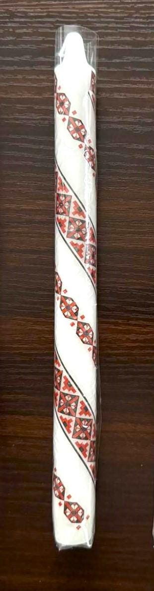 Handmade Ukrainian holiday candle with traditional red and white design, perfect for Christmas or Easter decor.