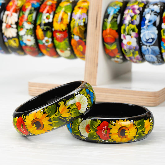 Hand-painted Petrykivka wooden bangles with vibrant floral designs, showcasing Ukrainian artistry and cultural heritage.