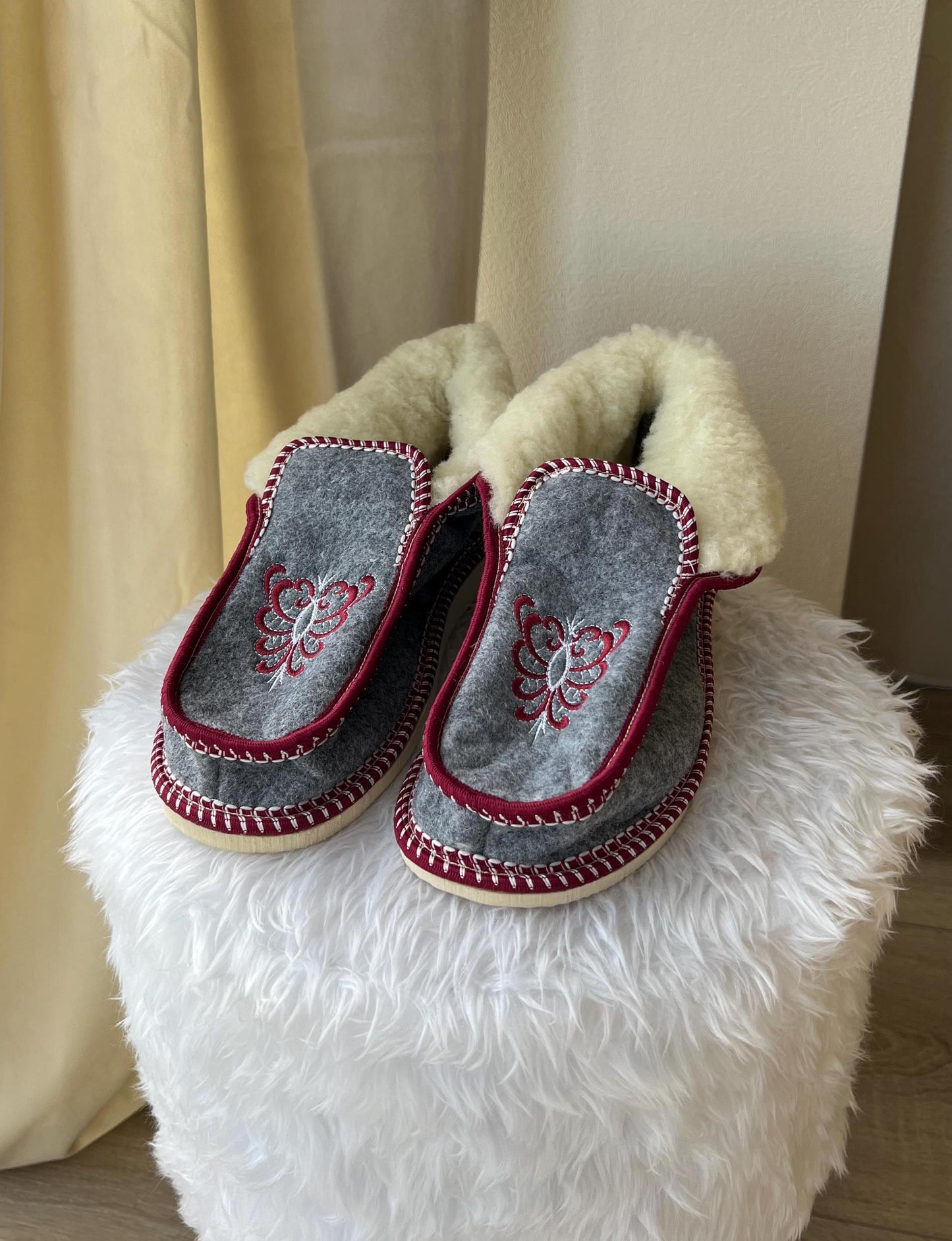 Handmade Carpathian wool slippers with Hutsul embroidery, featuring a cozy design, perfect Ukrainian Christmas gift.