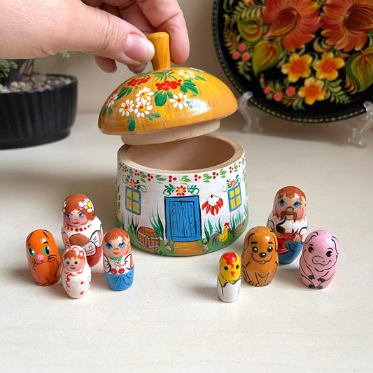 Ukrainian wooden house set with hand-painted family dolls featuring ethnic designs, ideal for kids' play and decor.