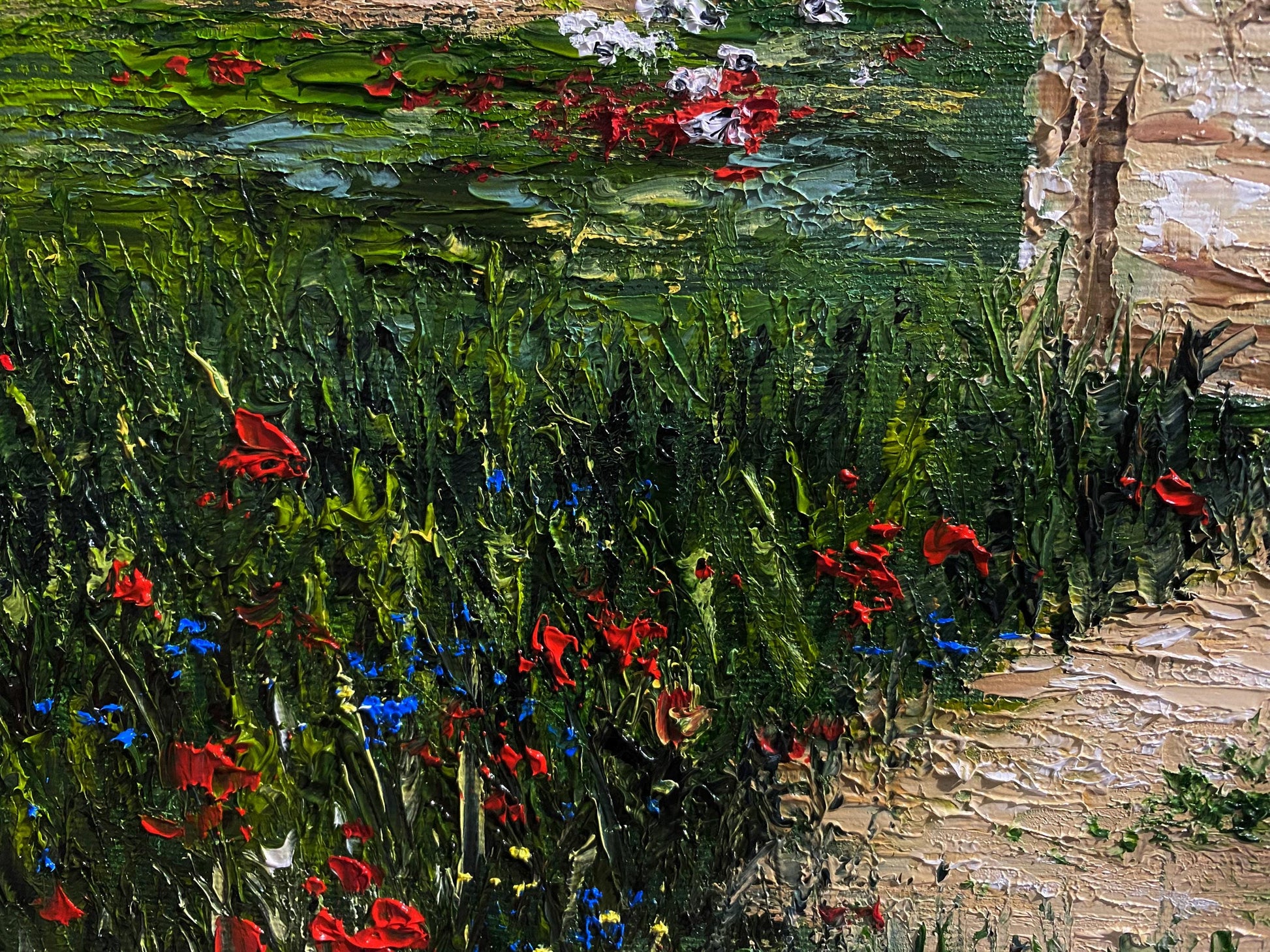 Close-up of textured oil painting depicting a lush meadow with red and blue flowers, part of an old Ukrainian windmill artwork.