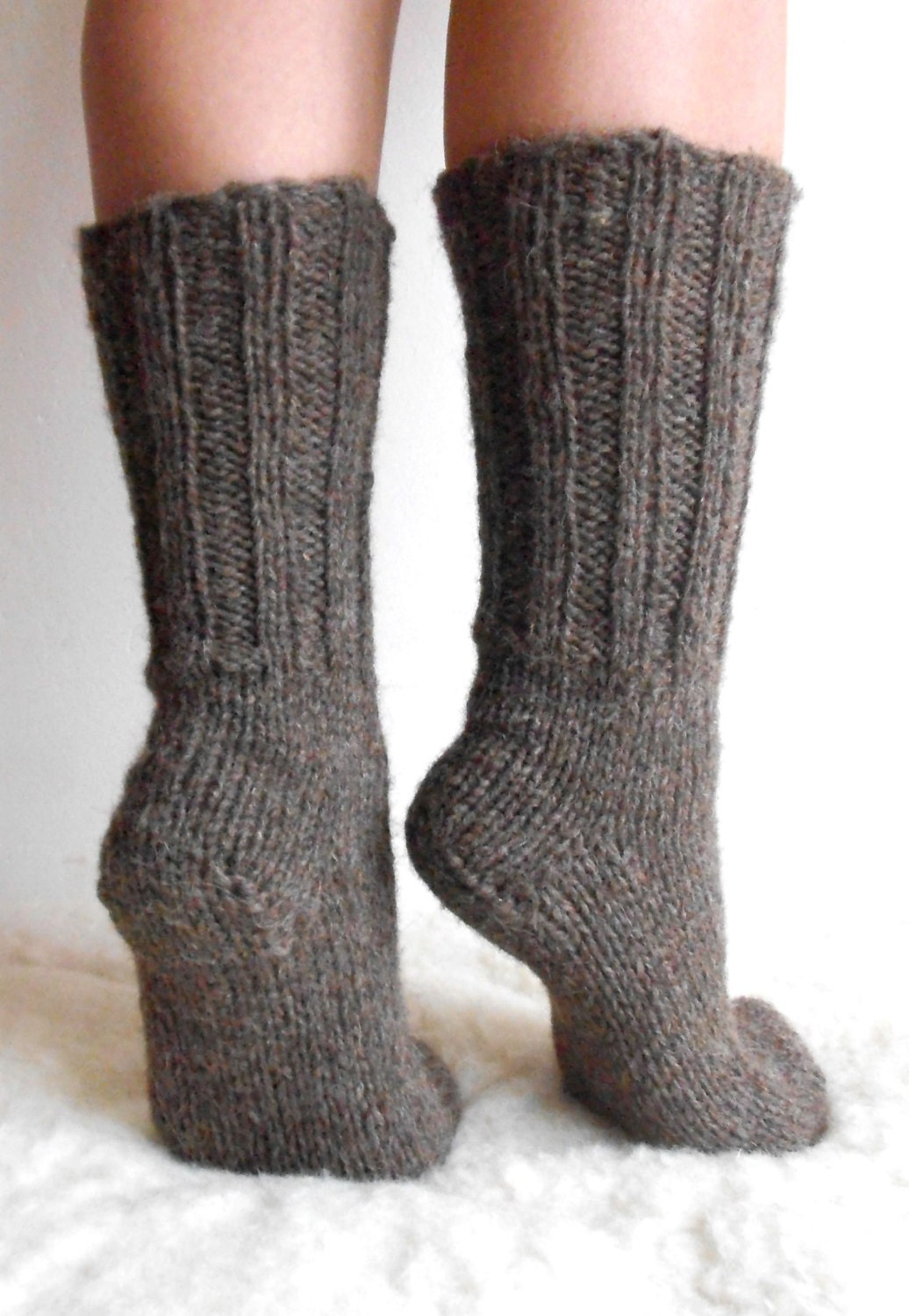 Hand-knitted wool socks made from 100% pure sheep wool, showcasing softness and warmth on feet.