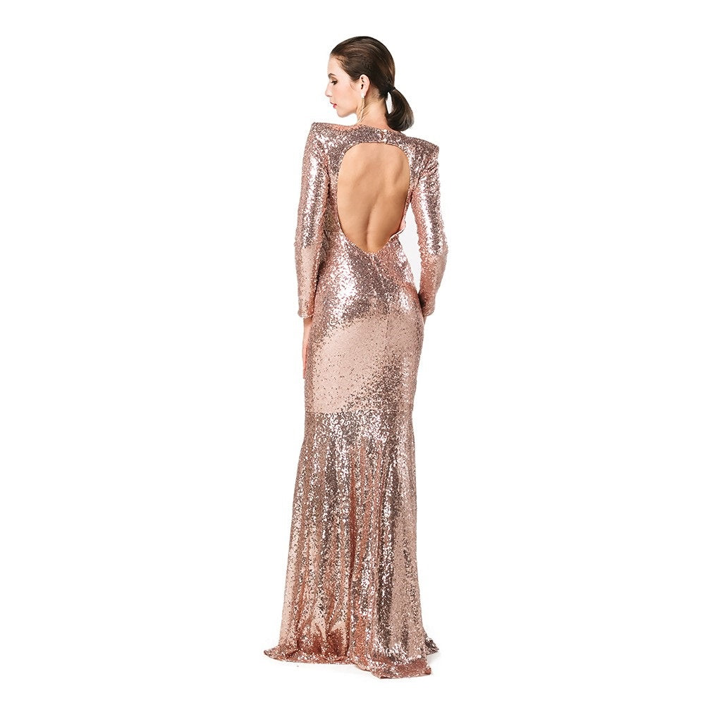 Woman wearing Orlienna Gold Sequin Open-Back Gown with long sleeves and flowing skirt, perfect for glamorous events.