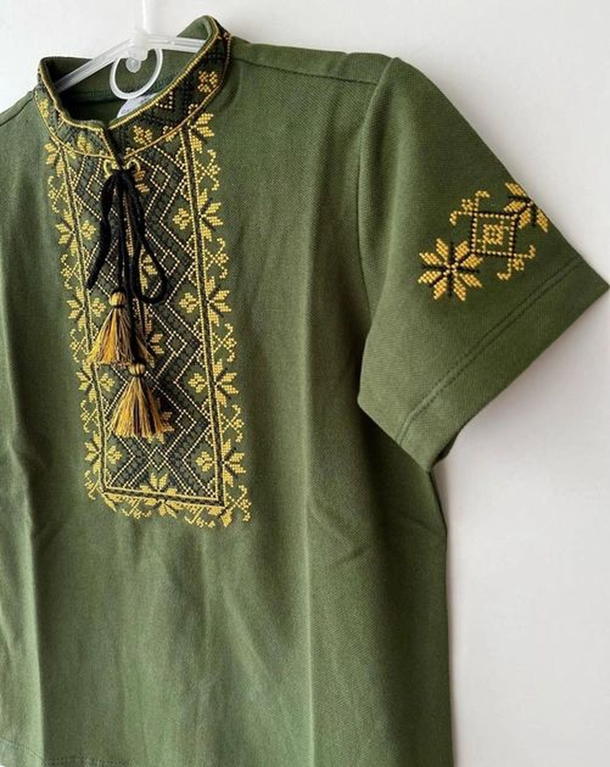 Khaki Ukrainian short sleeve embroidered shirt for boys, featuring traditional yellow cross-stitch patterns, perfect for cultural events.