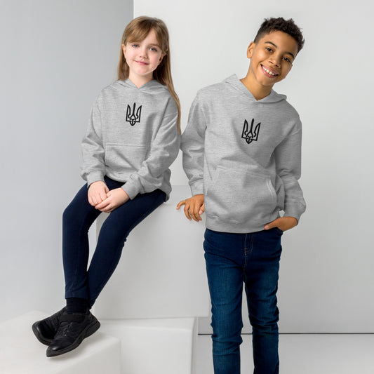 Kids wearing grey fleece hoodies with Ukrainian Tryzub design, sitting and standing, showcasing casual and comfortable fit.