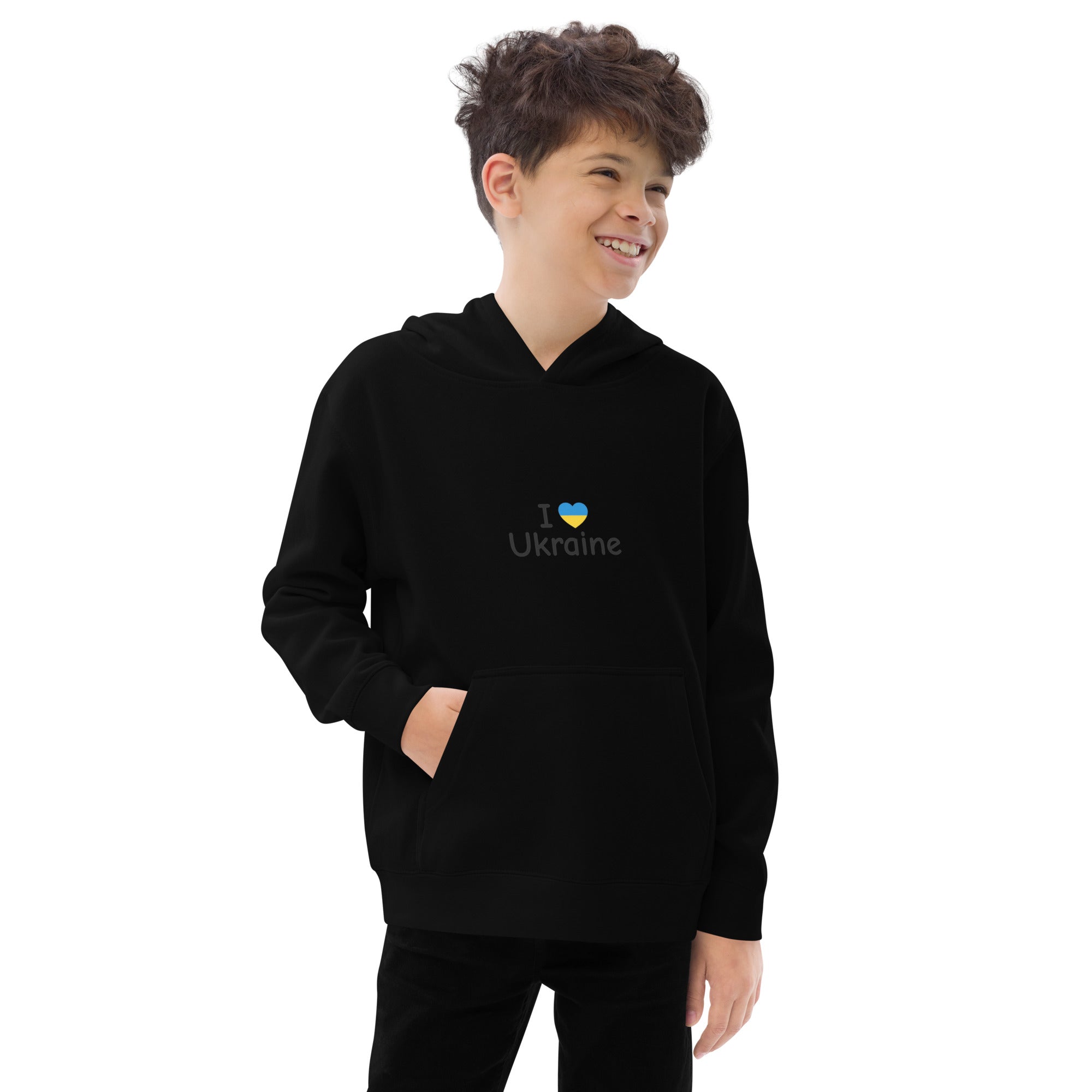 Boy wearing black kids fleece hoodie with "I Love Ukraine" design, smiling confidently.