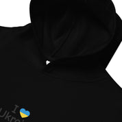Kids fleece hoodie with "I Love Ukraine" text and heart graphic on a black background.
