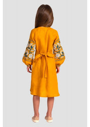 Rear view of a girl in a mustard linen Vyshyvanka dress with floral embroidery, showcasing long sleeves and a tie belt.
