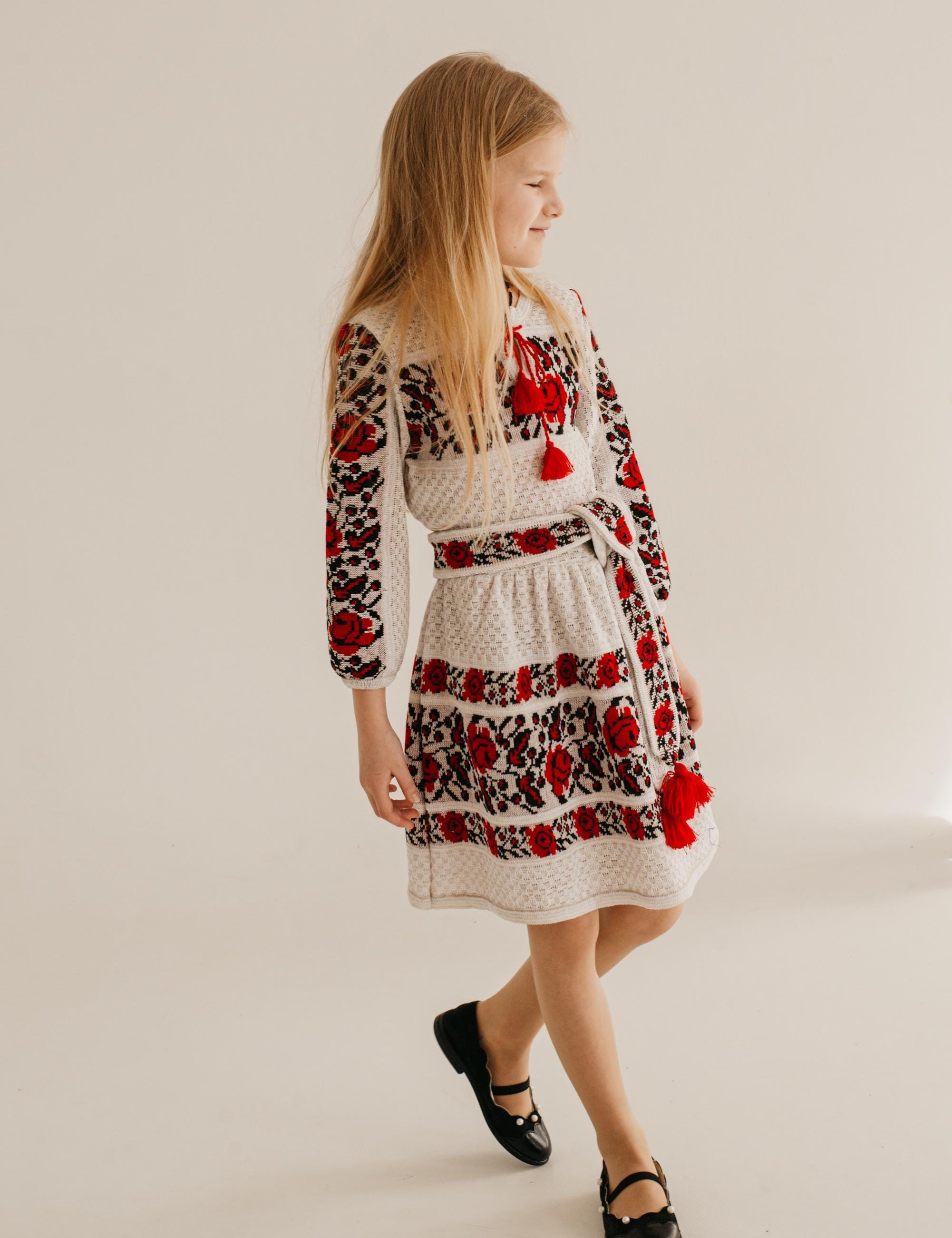 Girl wearing a knitted Ukrainian dress with traditional embroidery, combining cultural heritage and modern comfort.