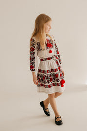 Girl wearing a knitted Ukrainian dress with traditional embroidery, combining cultural heritage and modern comfort.