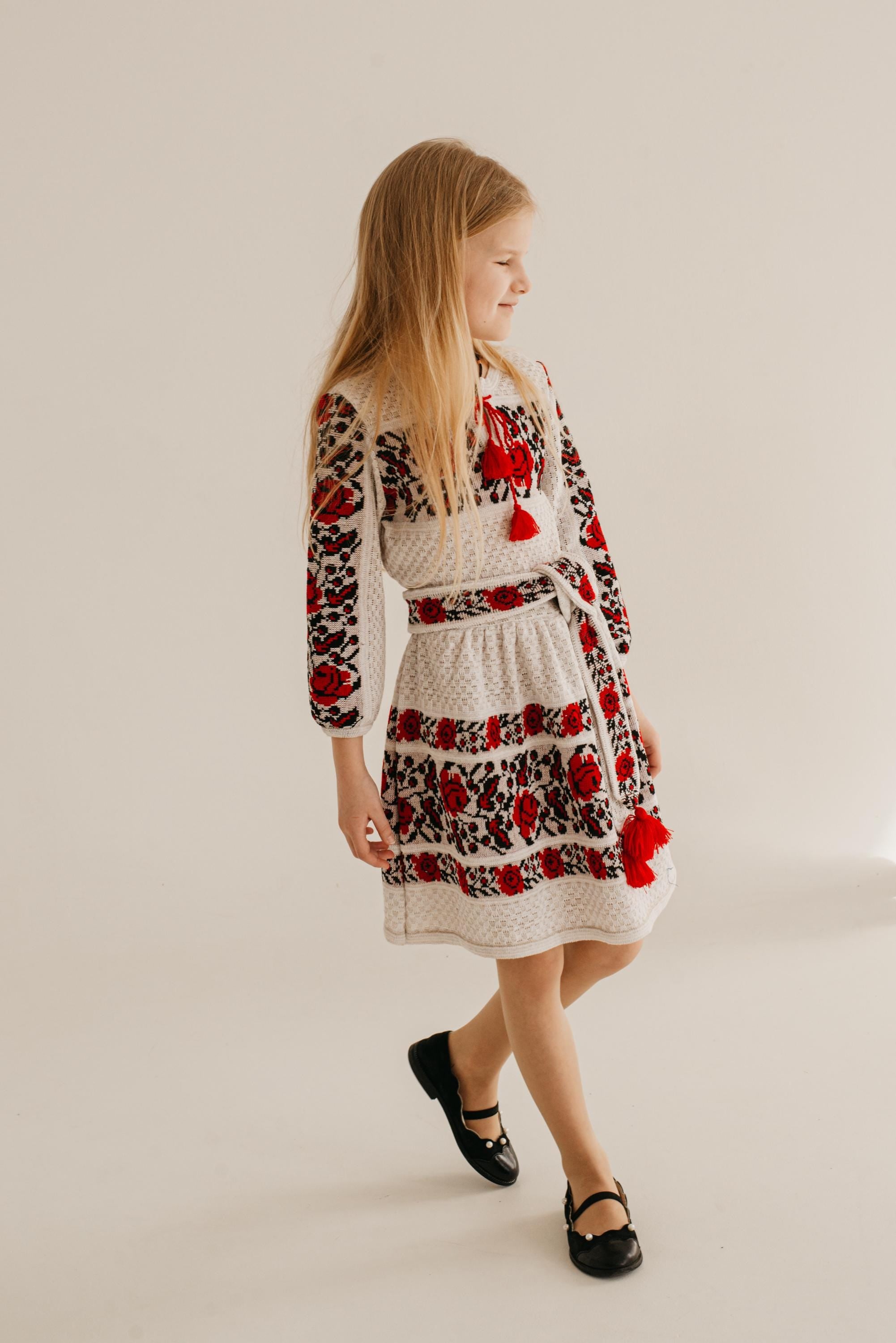 Girl wearing a knitted Ukrainian dress with traditional embroidery, combining cultural heritage and modern comfort.