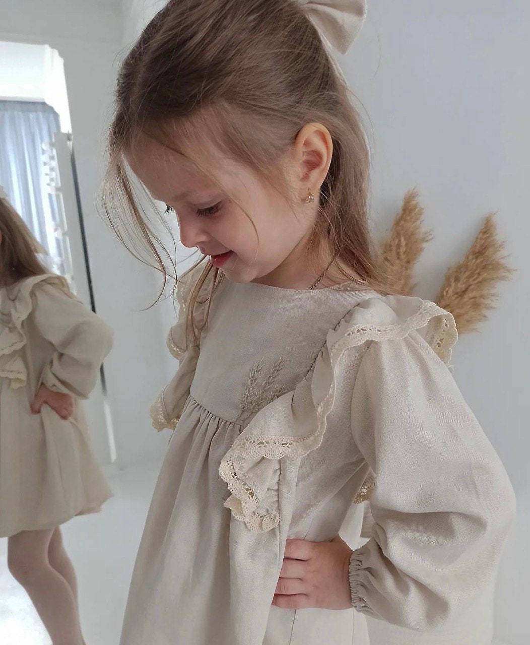 Girl wearing a light linen dress with lace trim, perfect for comfortable daily wear or a charming gift. Natural and breathable fabric.