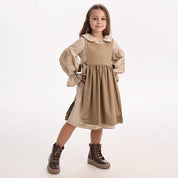 Little girl wearing a Ukrainian embroidery dress in Slavic ethnic style, showcasing traditional folk motifs. Linen-cotton blend fabric.