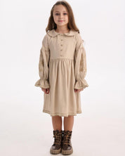 Girl wearing a beige linen embroidered dress with folk motifs, embracing Ukrainian Vyshyvanka and Slavic ethnic style.
