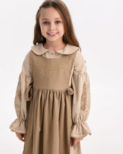 Girl wearing a linen embroidered Ukrainian Vyshyvanka dress with Slavic folk motifs