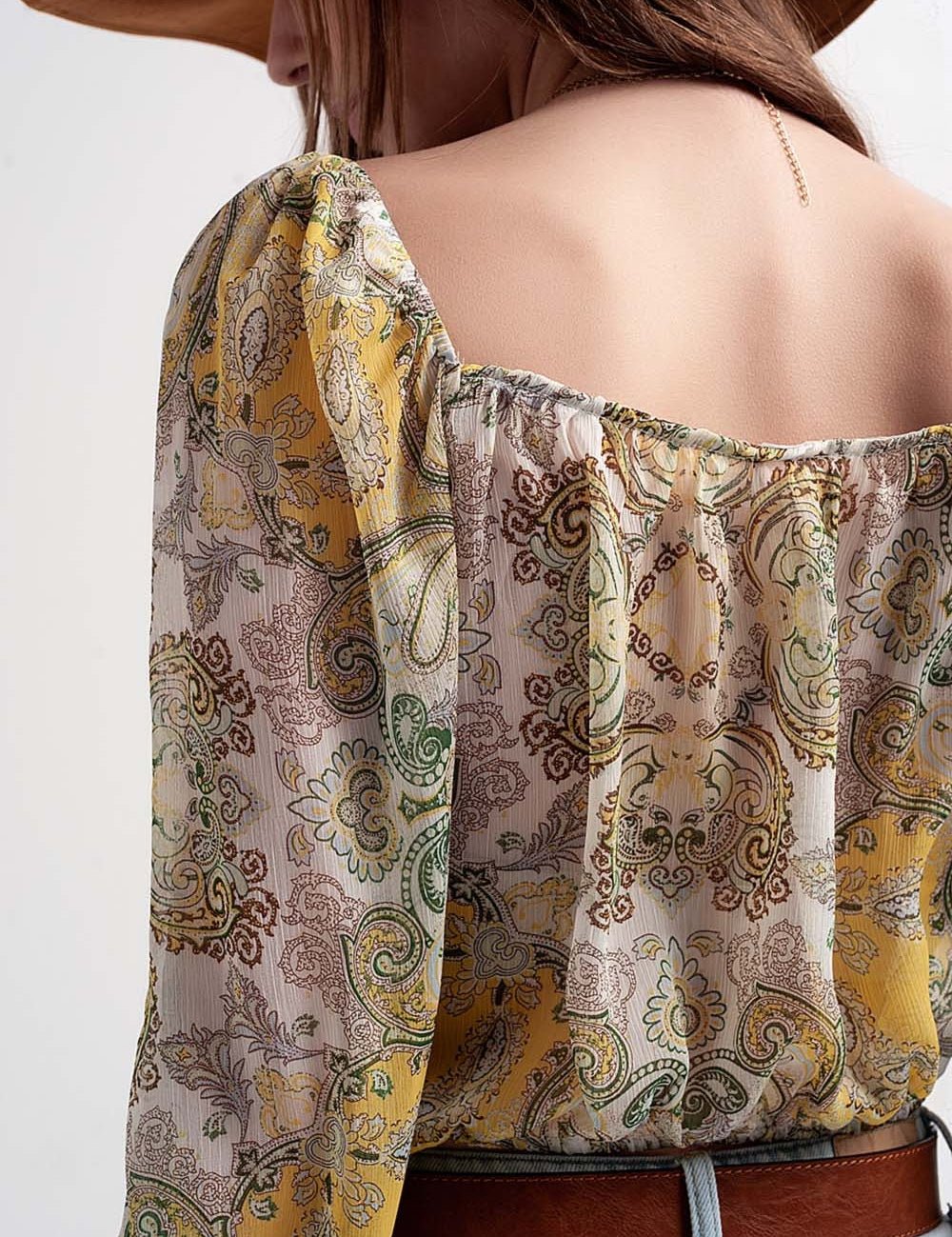 Back view of woman wearing Sirellin Sheer Boho Top with paisley print, showing off-shoulder design and relaxed fit.