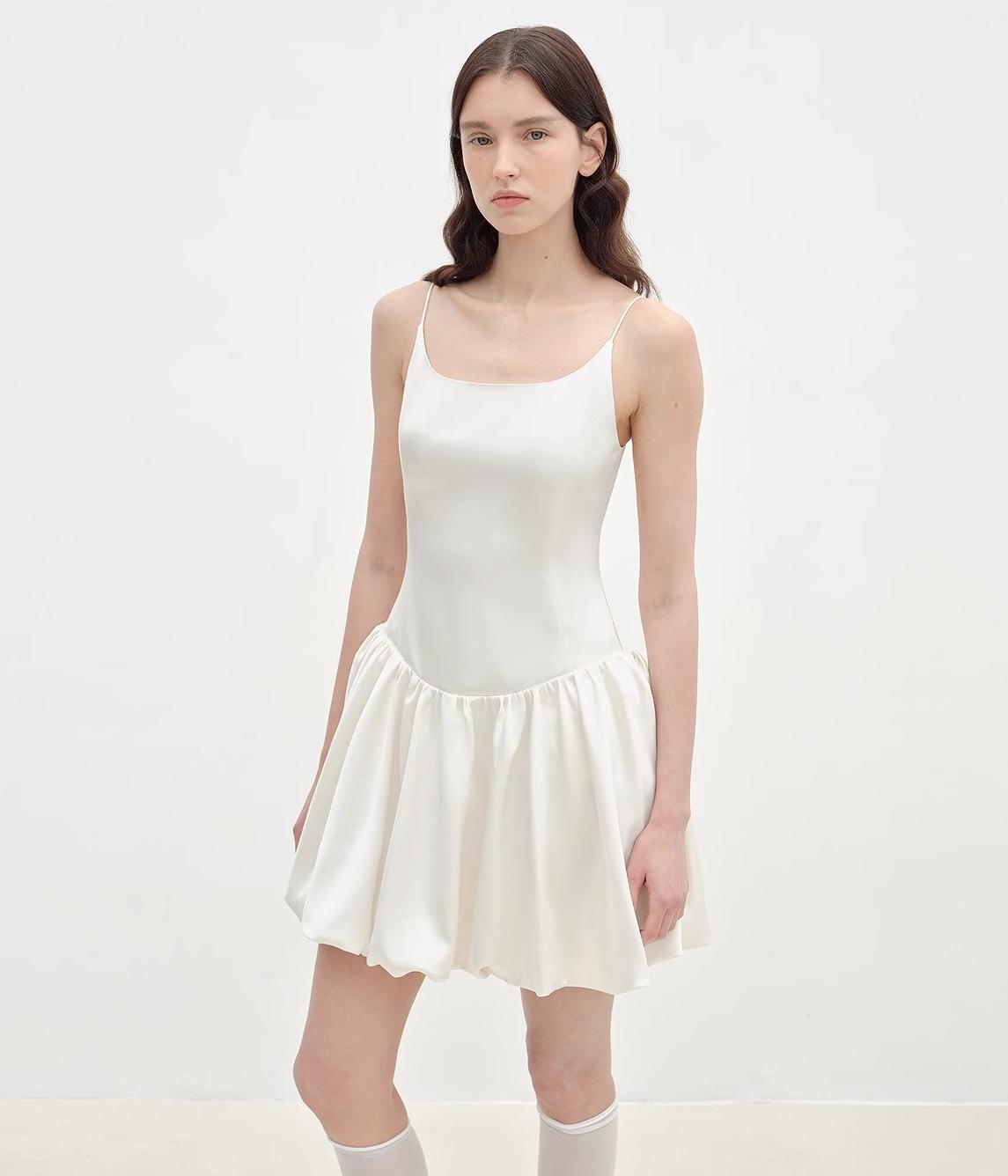 White satin ballet slip dress with slender straps and voluminous skirt, showcasing elegant design suitable for formal occasions.