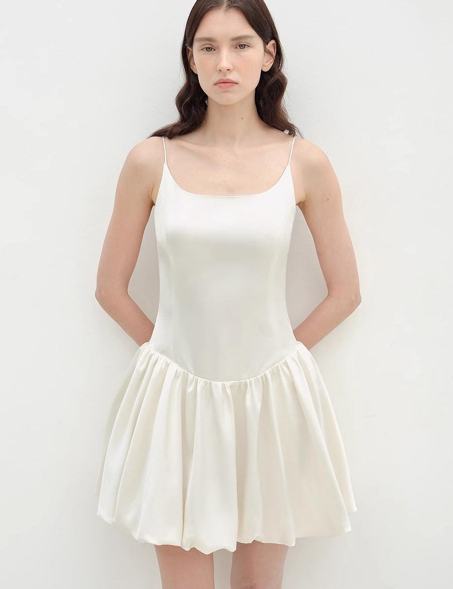 Woman wearing Lyrielle Satin Ballet Slip Dress with slender straps and voluminous skirt, showcasing a graceful ballet-inspired silhouette.