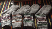 Handmade wool socks from Ukraine with colorful patterns, cozy and perfect for warmth and comfort, displayed on a patterned fabric.