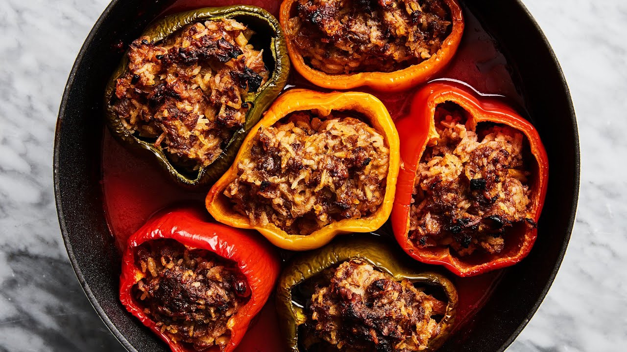 Homemade Ukrainian stuffed peppers with rice and meat filling in a pan, showcasing a traditional dish ready to enjoy.