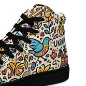 High top canvas shoe with colorful Ukrainian symbols, featuring a bird and floral patterns. Stylish and comfortable footwear design.