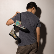 Person holding high top canvas shoes with Ukrainian symbolic design, showcasing trendy and stylish footwear.