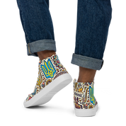 High top canvas shoes with Ukrainian symbolic design, showcasing vibrant patterns and a faux leather toe cap, worn with rolled-up jeans.