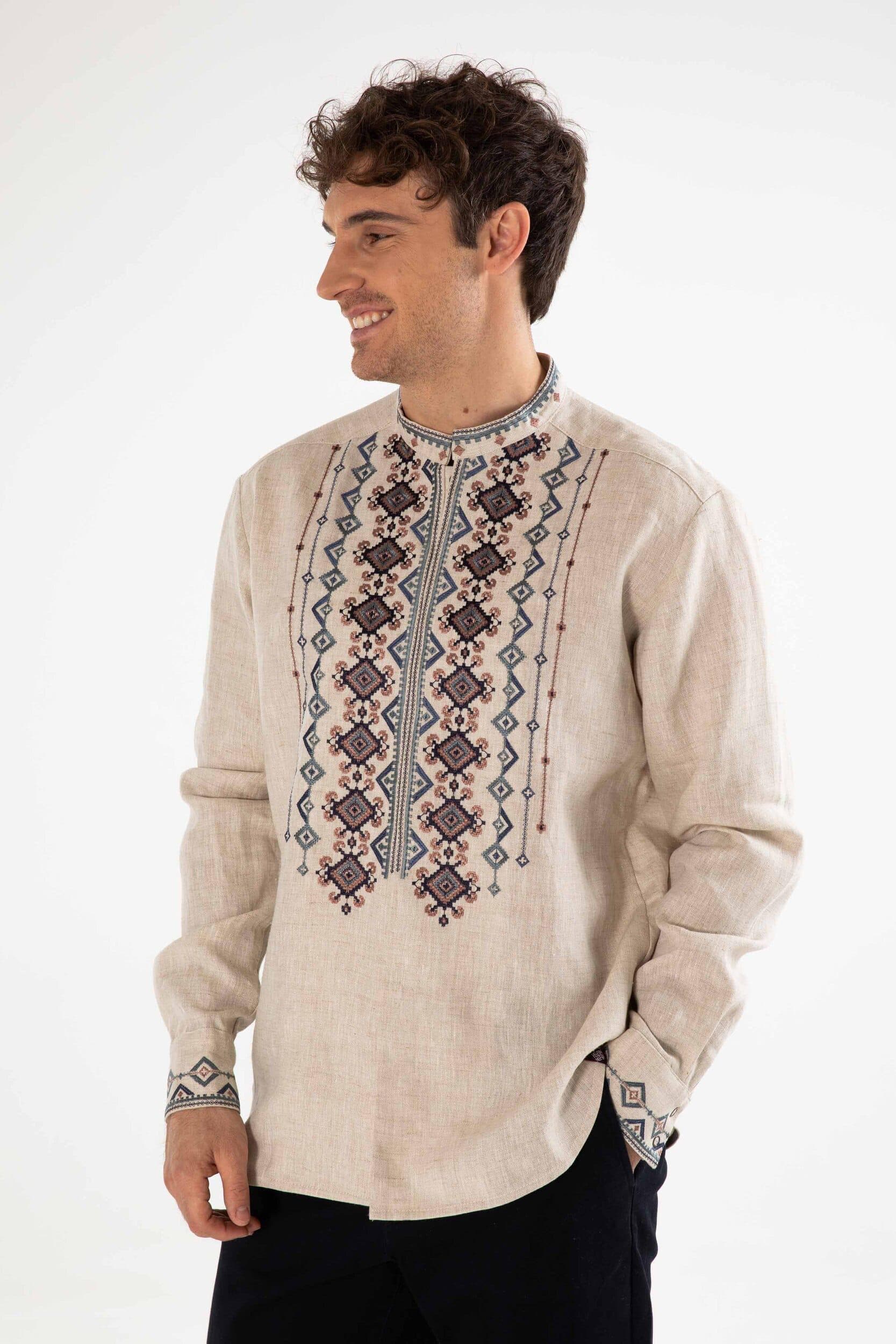Man wearing men's linen embroidered shirt in Ukrainian Vyshyvanka style with traditional folk motif and stand-up collar.