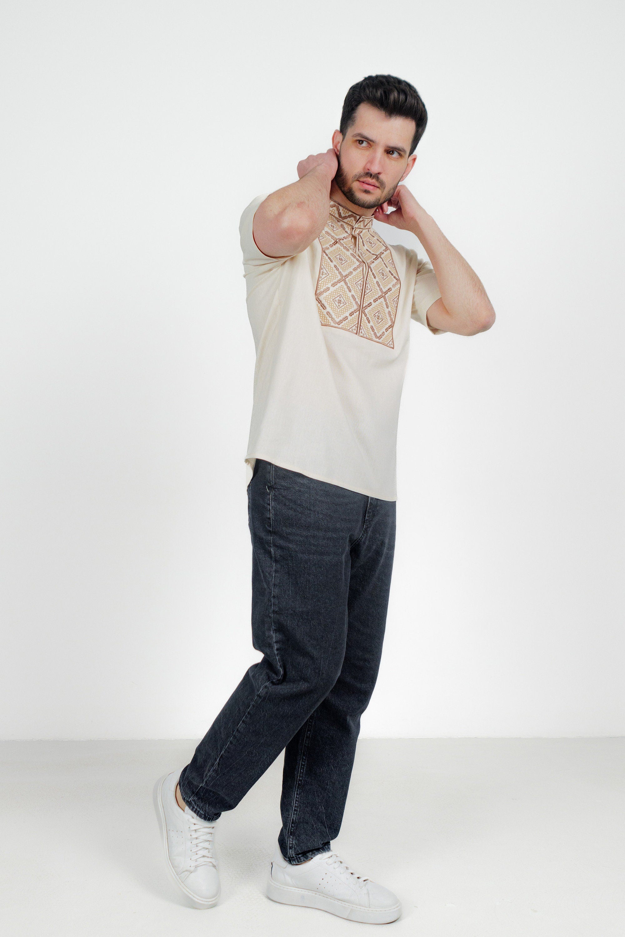 Men's short sleeve linen vyshyvanka shirt with geometric embroidery, worn by model, ideal for cultural celebrations and warm weather.