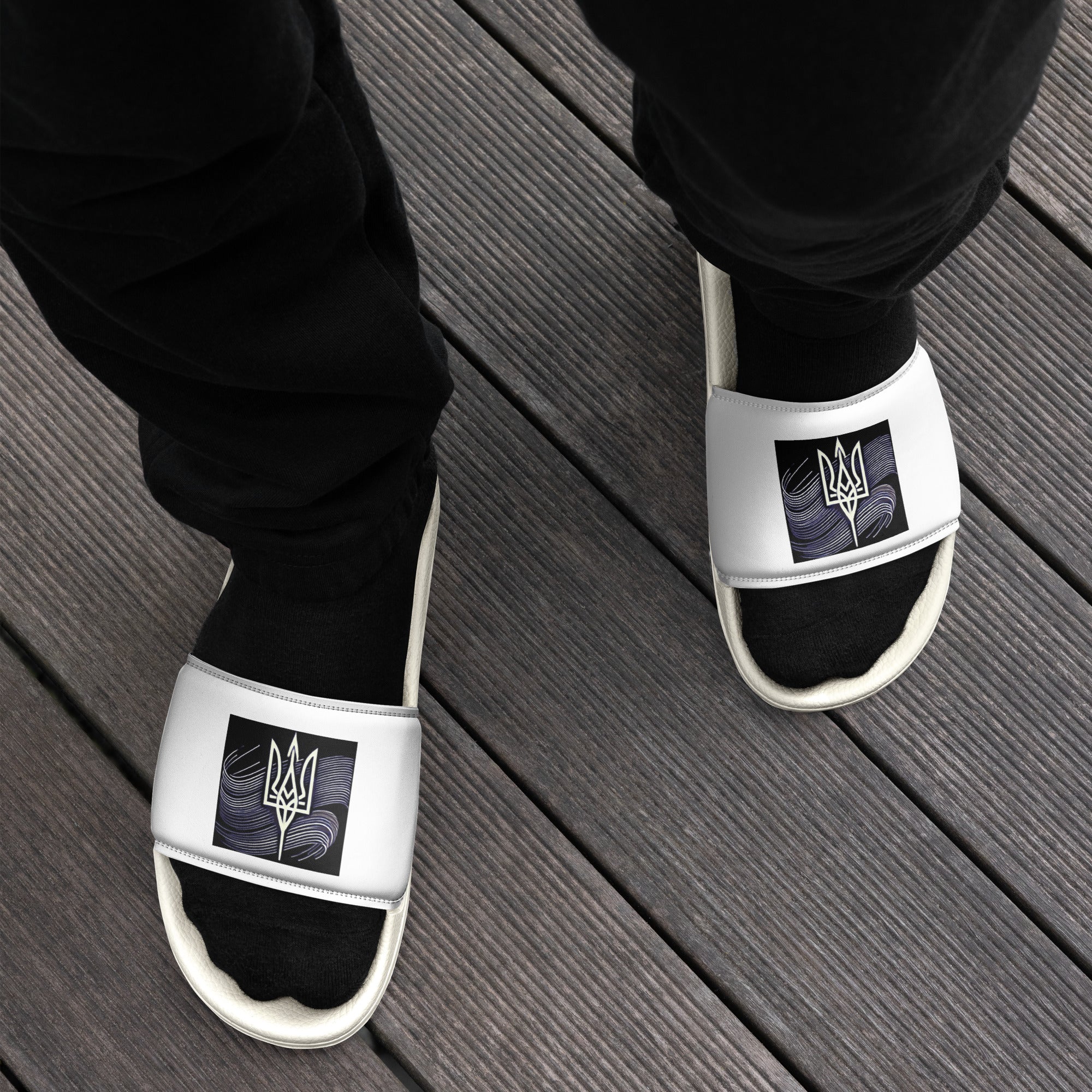 Black men's slip-on sandals featuring the Ukrainian Tryzub emblem, designed for comfort and durability, perfect for indoor and outdoor wear.