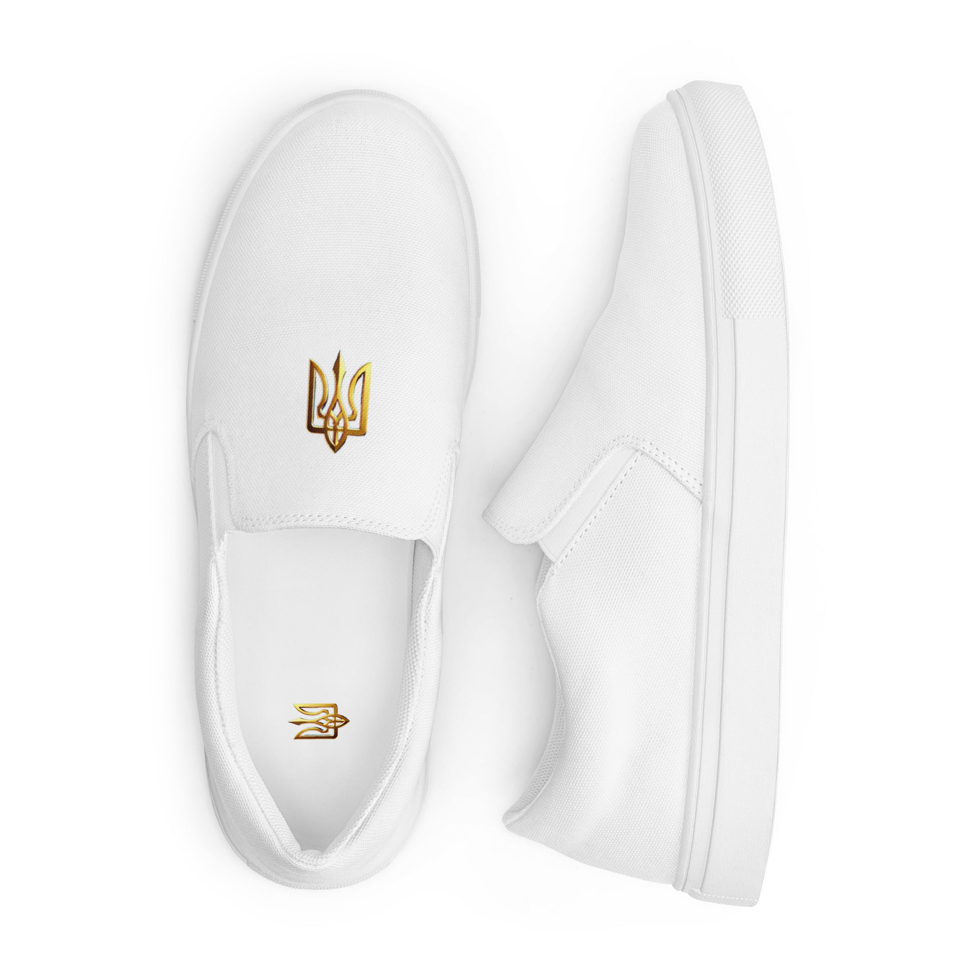White slip-on canvas shoes with gold Ukrainian Trizub design, featuring breathable lining and padded collar for comfort.