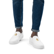 White slip-on canvas shoes with gold Ukrainian Trizub, worn with blue jeans for a stylish and comfortable look.