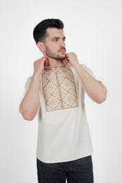 Man wearing a men's short sleeve Ukrainian embroidered shirt with geometric pattern, crafted from linen-cotton blend.