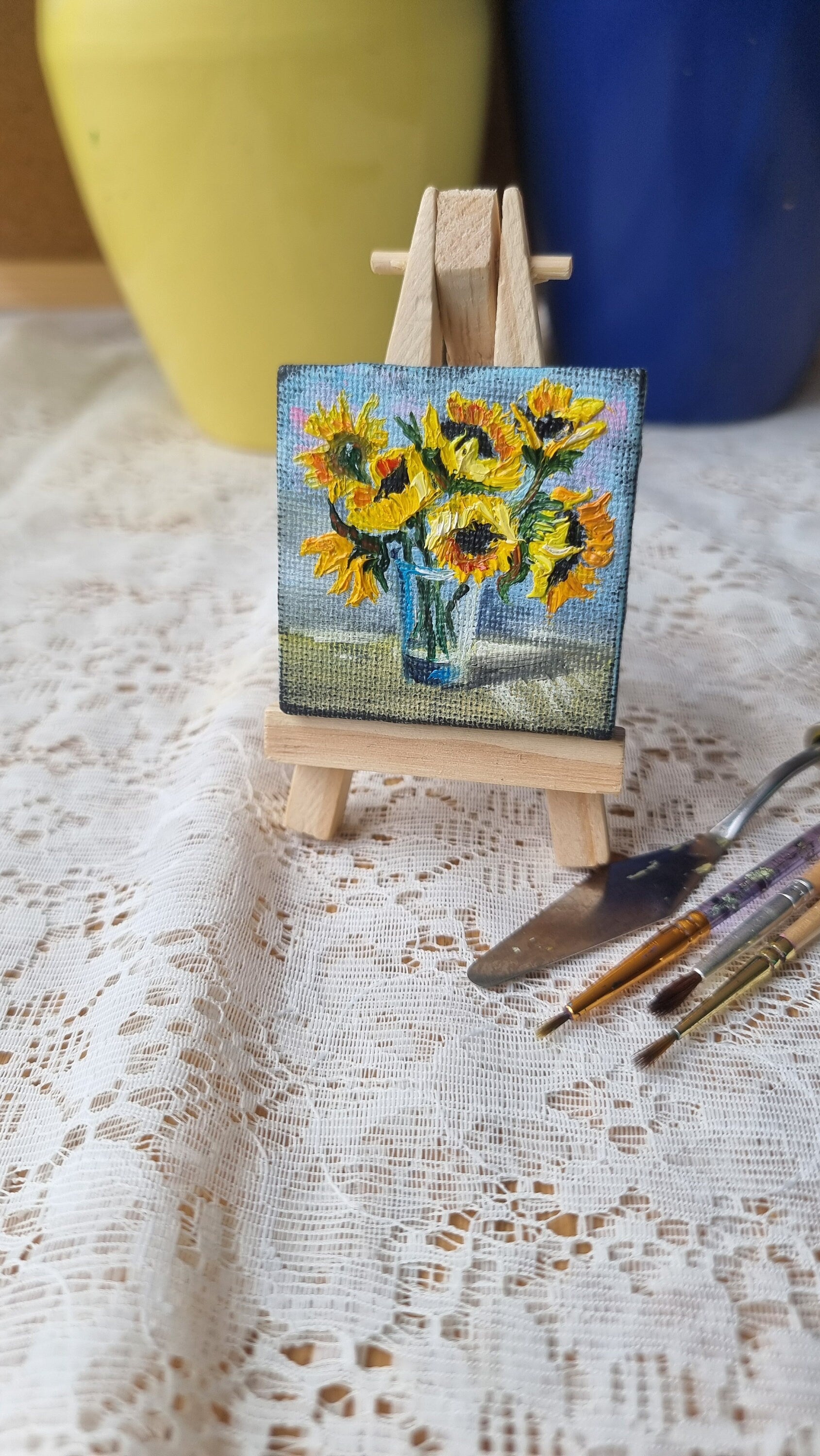 Miniature sunflower oil painting on easel, hand-painted Ukrainian art, 2x2 inch, vibrant bouquet symbolizing hope and resilience.