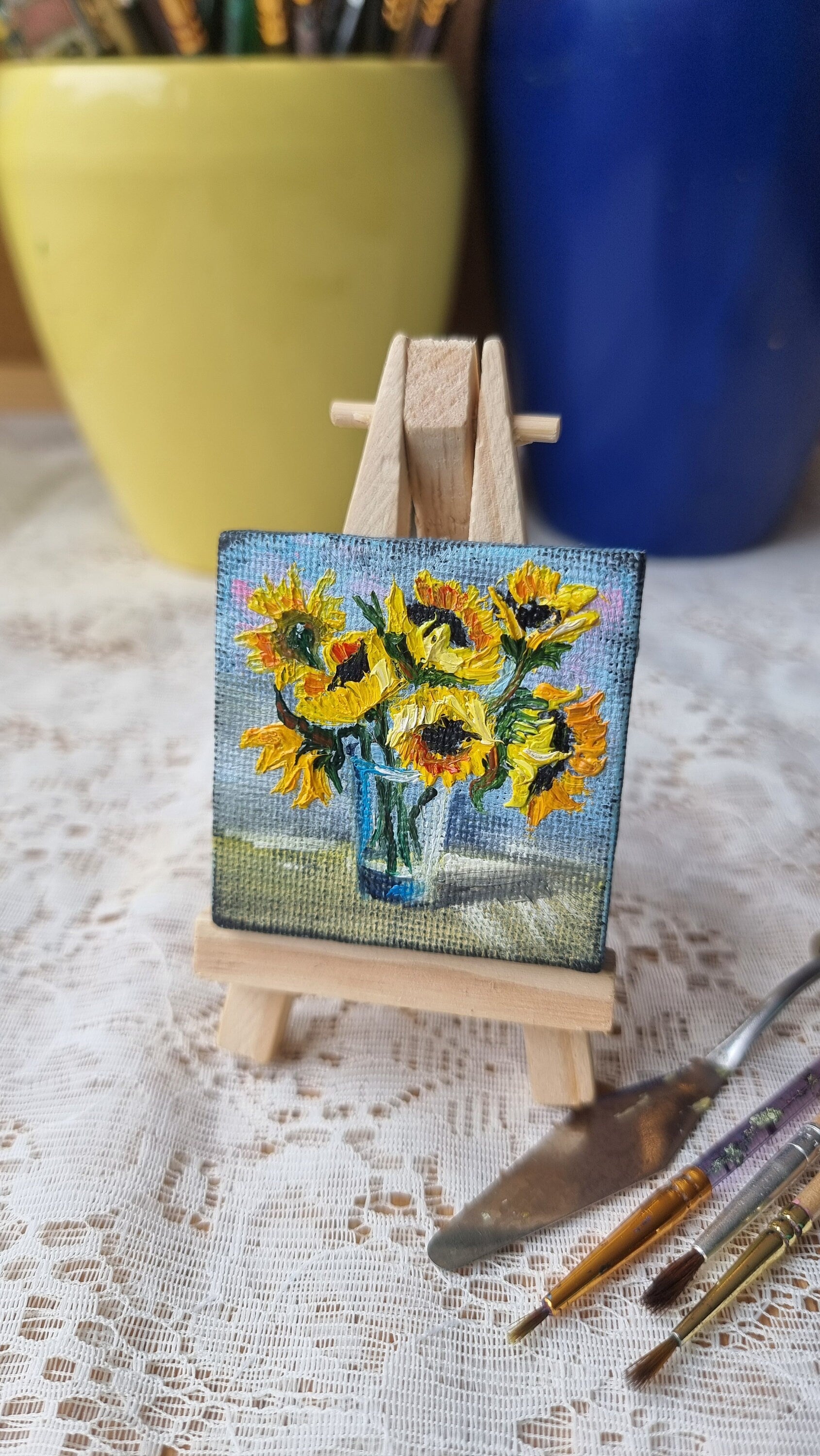 Miniature sunflower oil painting on easel, hand-painted Ukrainian art, 2x2 inch vibrant bouquet, symbol of hope and positivity.