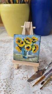 Miniature sunflower oil painting on easel, hand-painted Ukrainian art, 2x2 inch vibrant bouquet, symbol of hope and positivity.