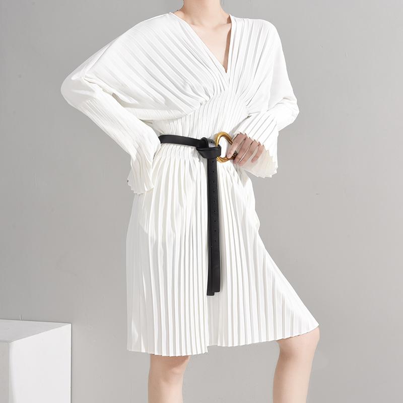 Naeris Pleated White Shirt Dress with V-neck, long sleeves, knee-length, and a black belt accent, showcasing a crisp cotton texture.