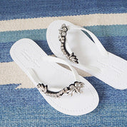 White rhinestone flat flip flop sandals for women with vintage motifs, handcrafted in New York. Ideal summer footwear choice.