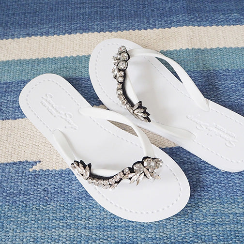 White rhinestone flat flip flop sandals for women with vintage motifs, handcrafted in New York. Ideal summer footwear choice.