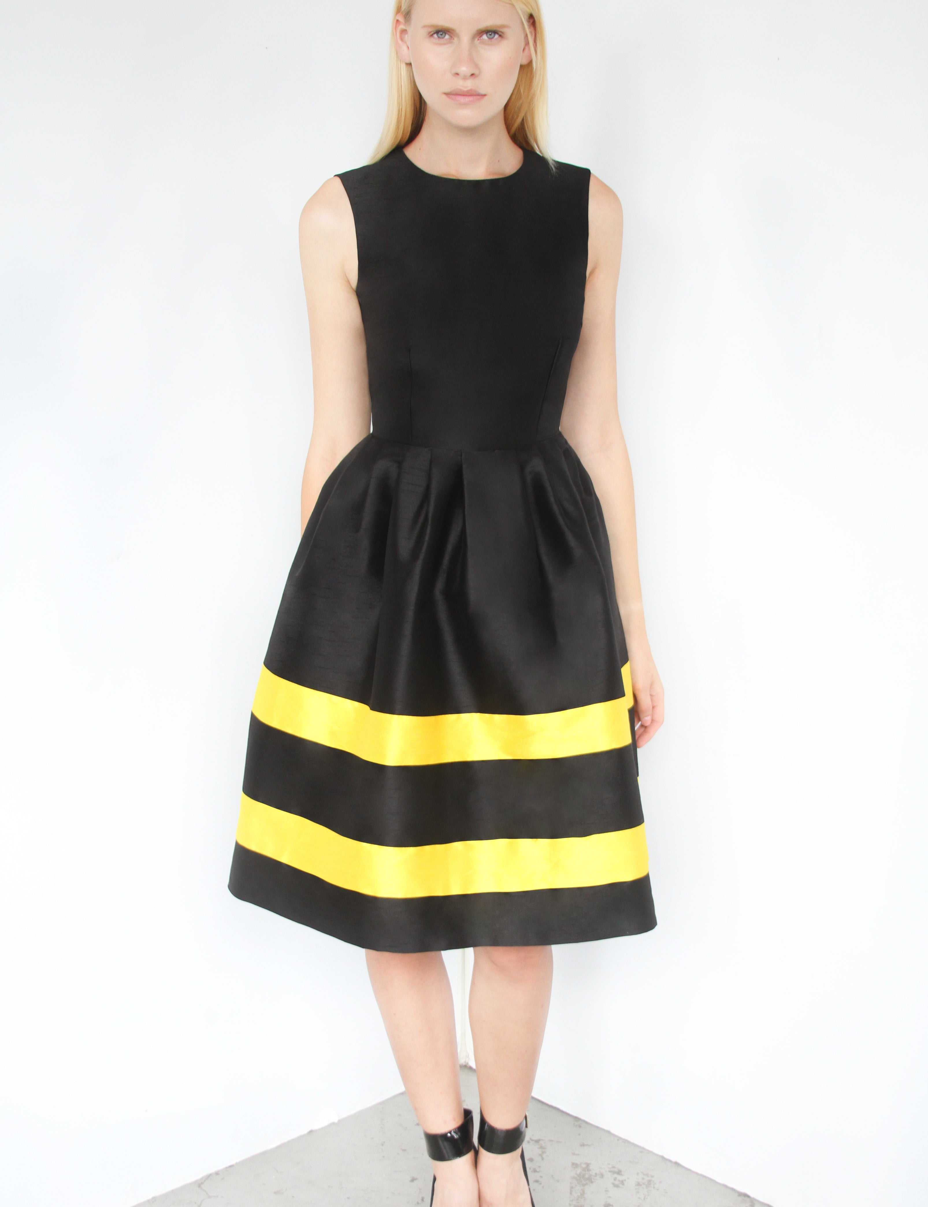Woman wearing black and yellow Stripe Reverie Dupioni Dress with sculptural full skirt and polished fit.