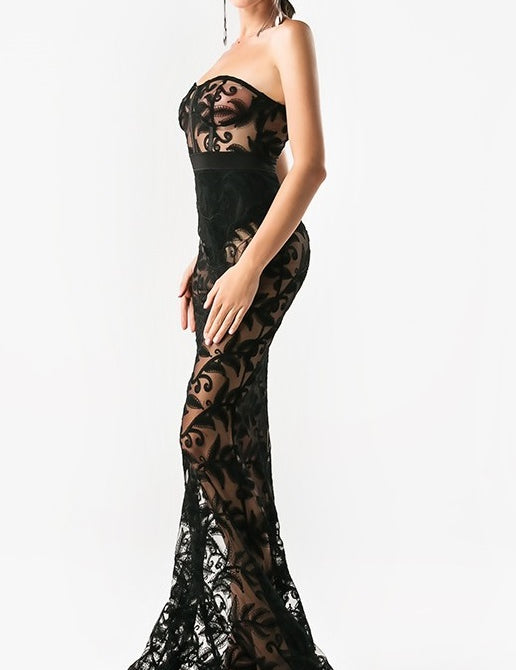 Woman wearing Noir Elegance black lace evening gown, showcasing the elegant silhouette, suitable for cocktail and prom events.