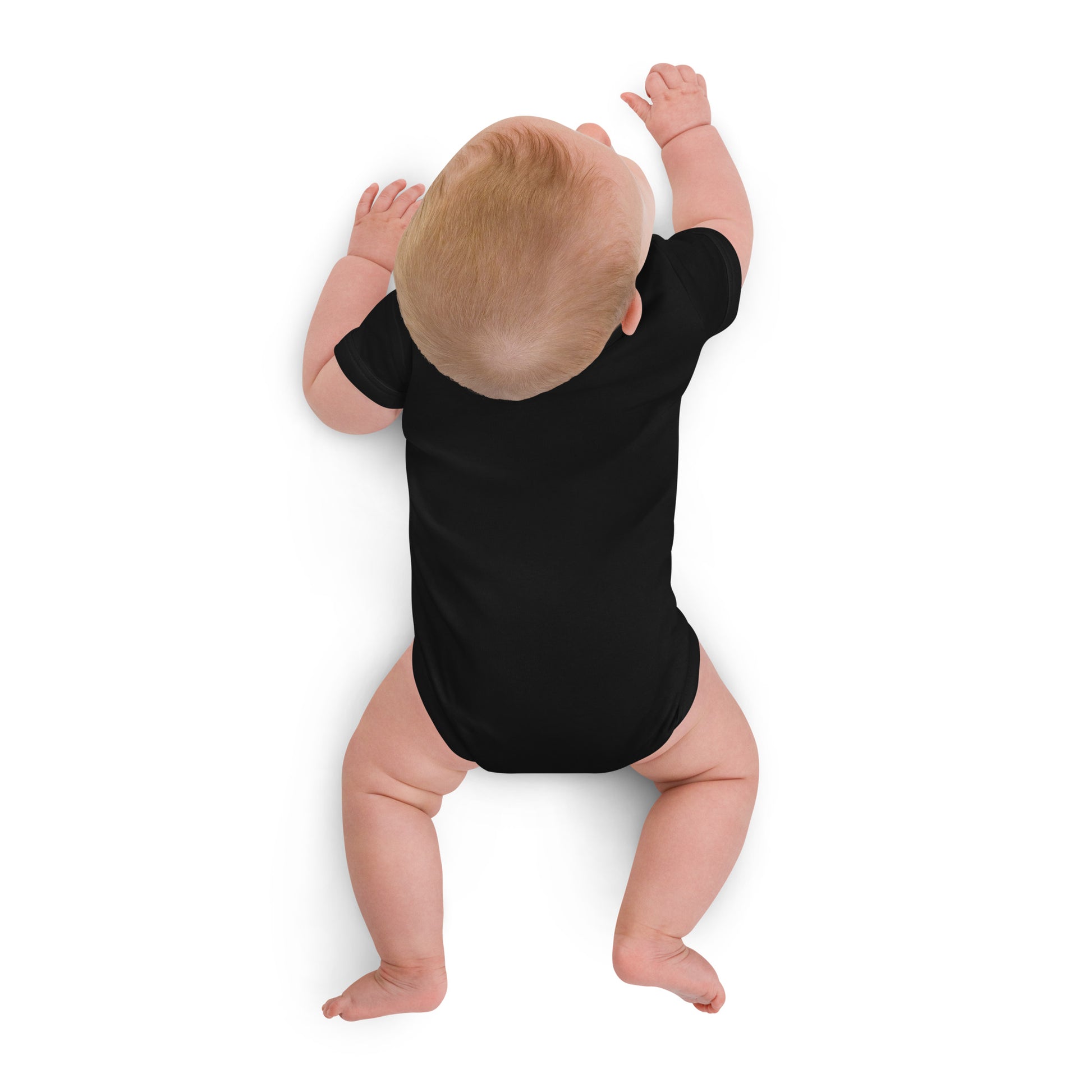 Baby wearing black organic cotton bodysuit featuring Ukrainian Tryzub logo, showcasing comfort and eco-friendly design.