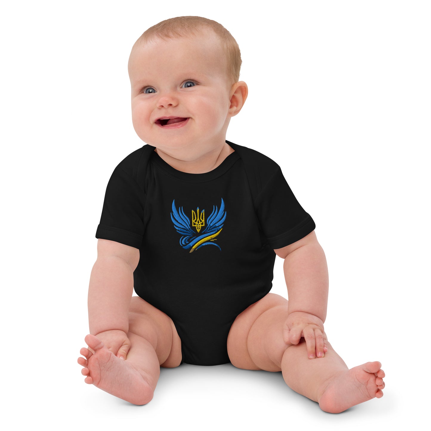 Baby wearing organic cotton bodysuit with Ukrainian Tryzub logo, showcasing comfort and heritage.